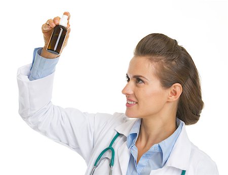 simsearch:400-07099882,k - Doctor woman looking on medicine bottle Photographie de stock - Aubaine LD & Abonnement, Code: 400-07099831