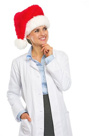 simsearch:400-07099823,k - Happy doctor woman in santa hat looking on copy space Stock Photo - Budget Royalty-Free & Subscription, Code: 400-07099846