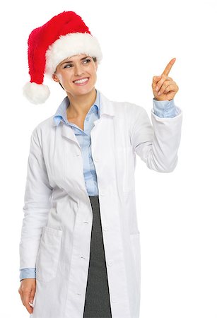 simsearch:400-07099823,k - Smiling doctor woman in santa hat pointing on copy space Stock Photo - Budget Royalty-Free & Subscription, Code: 400-07099848