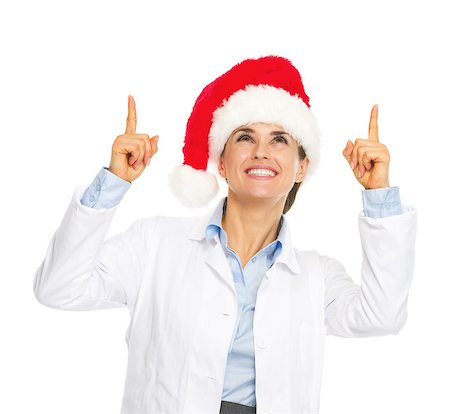 simsearch:400-07099823,k - Smiling doctor woman in santa hat pointing up on copy space Stock Photo - Budget Royalty-Free & Subscription, Code: 400-07099849
