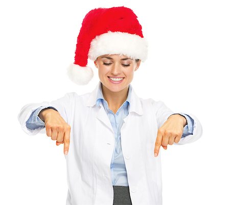 simsearch:400-07099823,k - Smiling doctor woman in santa hat pointing down on copy space Stock Photo - Budget Royalty-Free & Subscription, Code: 400-07099850