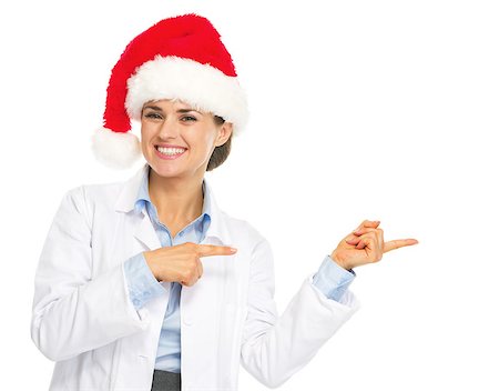 simsearch:400-07099823,k - Smiling doctor woman in santa hat pointing on copy space Stock Photo - Budget Royalty-Free & Subscription, Code: 400-07099851