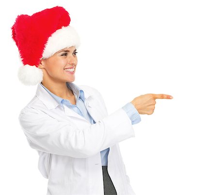 simsearch:400-07099823,k - Smiling doctor woman in santa hat pointing on copy space Stock Photo - Budget Royalty-Free & Subscription, Code: 400-07099852