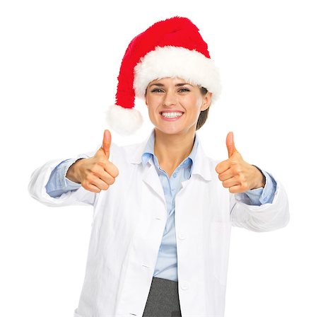 Smiling doctor woman in santa hat showing thumbs up Stock Photo - Budget Royalty-Free & Subscription, Code: 400-07099853