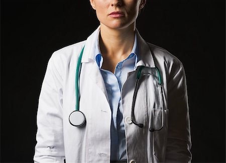 simsearch:400-07099882,k - Closeup on doctor woman isolated on black Photographie de stock - Aubaine LD & Abonnement, Code: 400-07099867