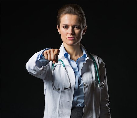 simsearch:400-07099882,k - Doctor woman pointing in camera isolated on black Photographie de stock - Aubaine LD & Abonnement, Code: 400-07099875