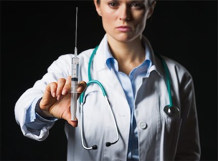 simsearch:400-07099823,k - Closeup on syringe in hand of doctor woman isolated on black Stock Photo - Budget Royalty-Free & Subscription, Code: 400-07099885