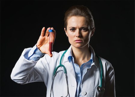 simsearch:400-07099889,k - Doctor woman showing test tube on black background Stock Photo - Budget Royalty-Free & Subscription, Code: 400-07099887