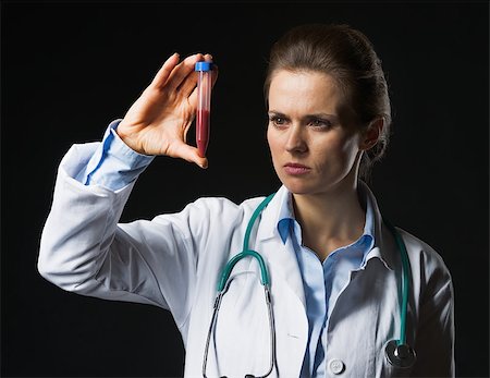 simsearch:400-04390415,k - Doctor woman looking on test tube on black background Stock Photo - Budget Royalty-Free & Subscription, Code: 400-07099888