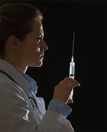 simsearch:400-07099823,k - Silhouette of doctor woman with syringe on black background Stock Photo - Budget Royalty-Free & Subscription, Code: 400-07099890