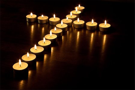 simsearch:400-07090264,k - Lit tea lights in the shape of a cross on a polished wooden surface. Stock Photo - Budget Royalty-Free & Subscription, Code: 400-07090264