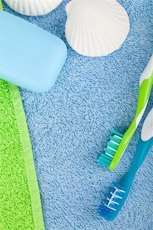 simsearch:400-08133885,k - Toothbrushes and soap over towels. View from above Photographie de stock - Aubaine LD & Abonnement, Code: 400-07090536
