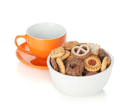simsearch:400-07090594,k - Various cookies in bowl and orange tea cup. Isolated on white background Foto de stock - Super Valor sin royalties y Suscripción, Código: 400-07090595