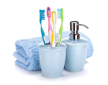 simsearch:400-04789848,k - Four colorful toothbrushes, liquid soap and towel. Isolated on white background Stock Photo - Budget Royalty-Free & Subscription, Code: 400-07090712