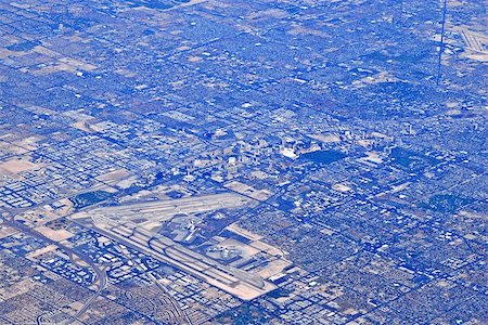 Aerial view of airport and urban sprawl. Fotografie stock - Microstock e Abbonamento, Codice: 400-07090838