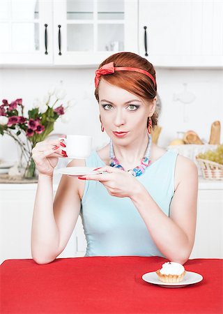 fat lady eating cake - Beautiful woman with cup of coffee on the kitchen Stock Photo - Budget Royalty-Free & Subscription, Code: 400-07090840