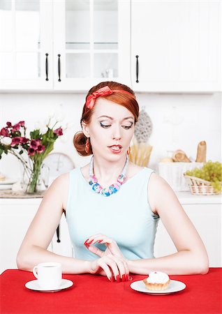 fat lady eating cake - Beautiful young woman looking on cake in the kitchen Stock Photo - Budget Royalty-Free & Subscription, Code: 400-07090841