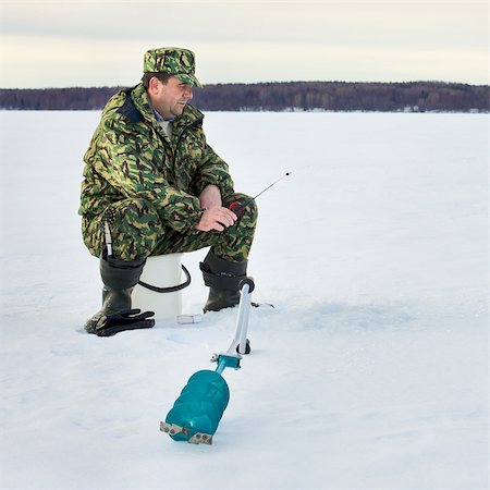 russia frozen lake - man fishing on the lake at winter Stock Photo - Budget Royalty-Free & Subscription, Code: 400-07091092