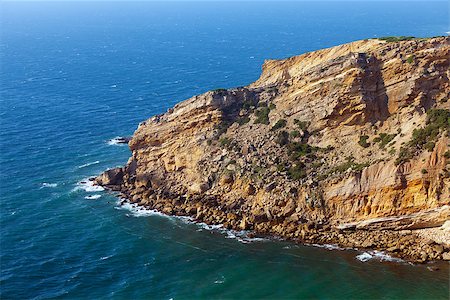 simsearch:400-05881592,k - View of a rugged coastline with steep barren cliffs falling down to a rocky shoreline with waves Foto de stock - Super Valor sin royalties y Suscripción, Código: 400-07092126