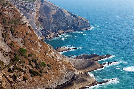 simsearch:400-05881592,k - View of a rugged coastline with steep barren cliffs falling down to a rocky shoreline with waves Foto de stock - Super Valor sin royalties y Suscripción, Código: 400-07092127