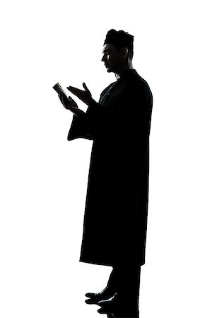 simsearch:614-02764159,k - one caucasian man priest reading bible silhouette in studio isolated on white background Stockbilder - Microstock & Abonnement, Bildnummer: 400-07093103