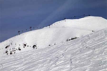 simsearch:400-08780271,k - Off-piste slope and ropeway against blue sky. Caucasus Mountains. Georgia, ski resort Gudauri. Mt. Sadzele. Photographie de stock - Aubaine LD & Abonnement, Code: 400-07093258