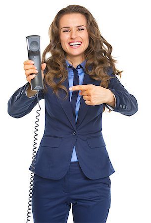 simsearch:400-06139245,k - Smiling business woman pointing on phone handset Foto de stock - Royalty-Free Super Valor e Assinatura, Número: 400-07106799