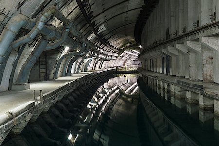 Underground Tunnel with Water for passage and repair submarines. Stockbilder - Microstock & Abonnement, Bildnummer: 400-07107920