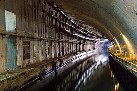 simsearch:400-06922670,k - Illuminated Underground Tunnel with Water for passage and repair submarines. Stock Photo - Budget Royalty-Free & Subscription, Code: 400-07107921