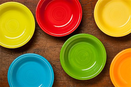 colorful ceramic bowls on a grunge weathered wood table - top view Stock Photo - Budget Royalty-Free & Subscription, Code: 400-07108194