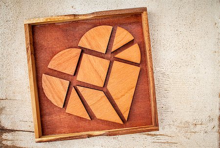simsearch:400-07774007,k - broken heart - tangram pieces in a box, a traditional Chinese Puzzle Game made of different wood parts to build abstract figures from them, on white painted barn wood Foto de stock - Royalty-Free Super Valor e Assinatura, Número: 400-07108201