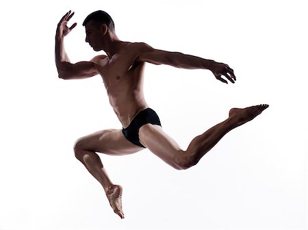 pattuglia acrobatica - caucasian man gymnastic run leap posture isolated studio on white background Fotografie stock - Microstock e Abbonamento, Codice: 400-07101537