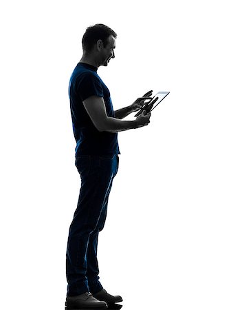 people ipad computer studio - one caucasian man touchscreen digital tablet   in silhouette on white background Stock Photo - Budget Royalty-Free & Subscription, Code: 400-07101538