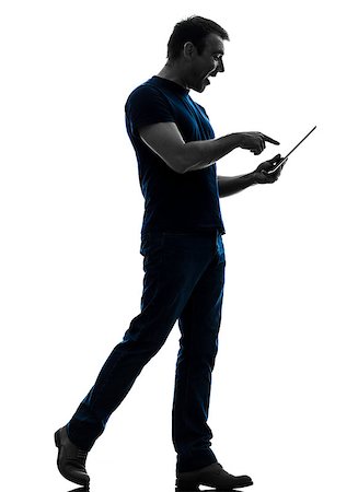 full body man standing alone holding tablet - one caucasian man touchscreen digital tablet   in silhouette on white background Stock Photo - Budget Royalty-Free & Subscription, Code: 400-07101539