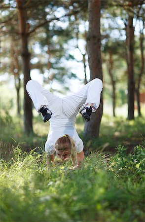 Young woman making asana pose in the park Stock Photo - Budget Royalty-Free & Subscription, Code: 400-07101733