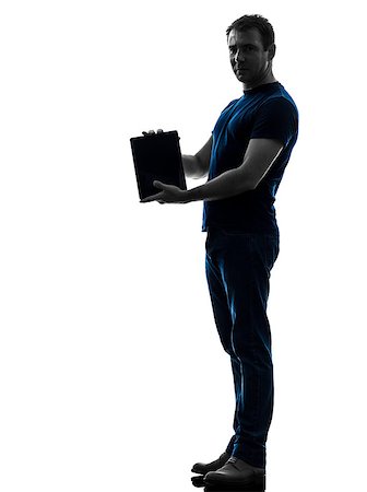 full body man standing alone holding tablet - one caucasian man holding  showing digital tablet   in silhouette on white background Stock Photo - Budget Royalty-Free & Subscription, Code: 400-07103081