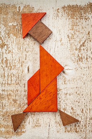 simsearch:400-07774007,k - abstract figure of a walking woman built from seven tangram wooden pieces, a traditional Chinese puzzle game; rough white painted barn wood background Foto de stock - Royalty-Free Super Valor e Assinatura, Número: 400-07103318