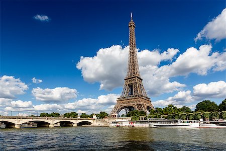 eifel - Eiffel Tower and Seine River with White Clouds in Background, Paris, France Fotografie stock - Microstock e Abbonamento, Codice: 400-07114384