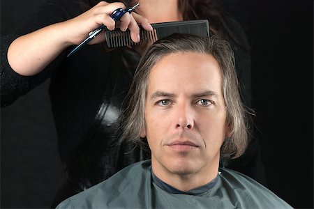 Close-up of a serious man looking to camera while his hair is combed in preparation for having it cut off for a cancer fundraiser. Stock Photo - Budget Royalty-Free & Subscription, Code: 400-07115681