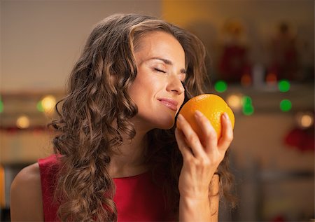 decor home new year - Happy woman enjoying orange in christmas decorated kitchen Stock Photo - Budget Royalty-Free & Subscription, Code: 400-07116219
