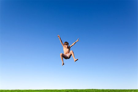 simsearch:400-04215852,k - Happy young boy jumping in the meadow Stock Photo - Budget Royalty-Free & Subscription, Code: 400-07111421