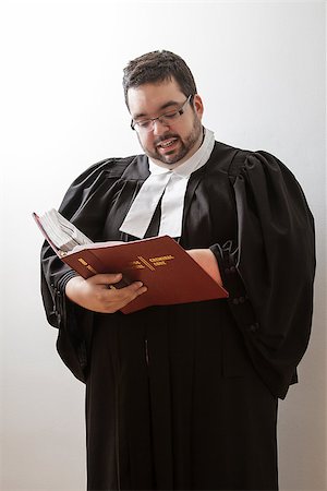 Overweight man in canadian lawyer toga, holding a red bilingual criminal law book and reading in it Stock Photo - Budget Royalty-Free & Subscription, Code: 400-07111548