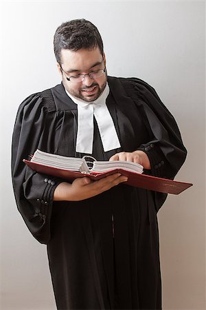 Overweight man in canadian lawyer toga, holding a red bilingual criminal law book and reading in it Stock Photo - Budget Royalty-Free & Subscription, Code: 400-07111549