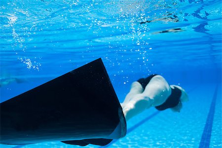 female underwater still - Female freediver with monofin swimming underwater in swimming pool Stock Photo - Budget Royalty-Free & Subscription, Code: 400-07112148