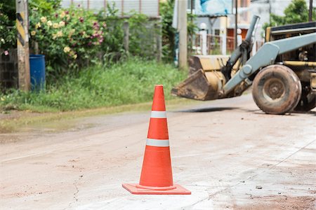 street cleaning - bulldozer performing road construction with orange cones. Photographie de stock - Aubaine LD & Abonnement, Code: 400-07112204