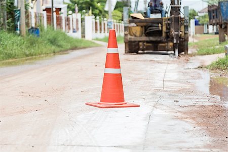 street cleaning - bulldozer performing road construction with orange cones. Photographie de stock - Aubaine LD & Abonnement, Code: 400-07112205