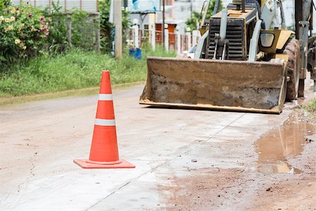 street cleaning - bulldozer performing road construction with orange cones. Photographie de stock - Aubaine LD & Abonnement, Code: 400-07112203