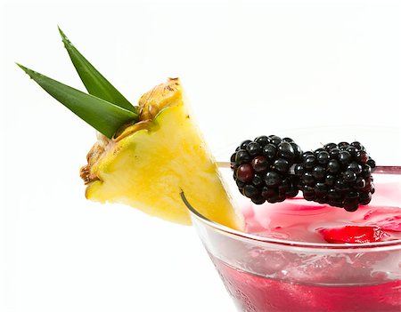simsearch:400-06797125,k - cocktail served in a stemless martini glass garnished with a pineapple slice and blackberries isolated on a white background Stock Photo - Budget Royalty-Free & Subscription, Code: 400-07112363