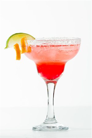 salt rim - refreshing raspberry margarita isolated on a white background garnished with a lime and an orange twist Stock Photo - Budget Royalty-Free & Subscription, Code: 400-07113806
