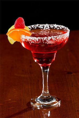 simsearch:400-06797125,k - refreshing raspberry margarita isolated dark bar garnished with a lime wedge and an orange twist Stock Photo - Budget Royalty-Free & Subscription, Code: 400-07113802